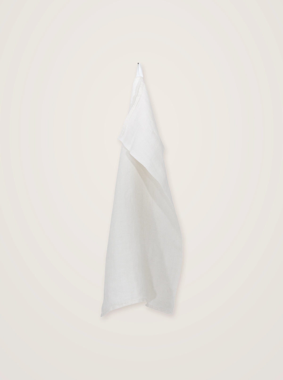 White double-woven linen towel hanging by its integrated loop