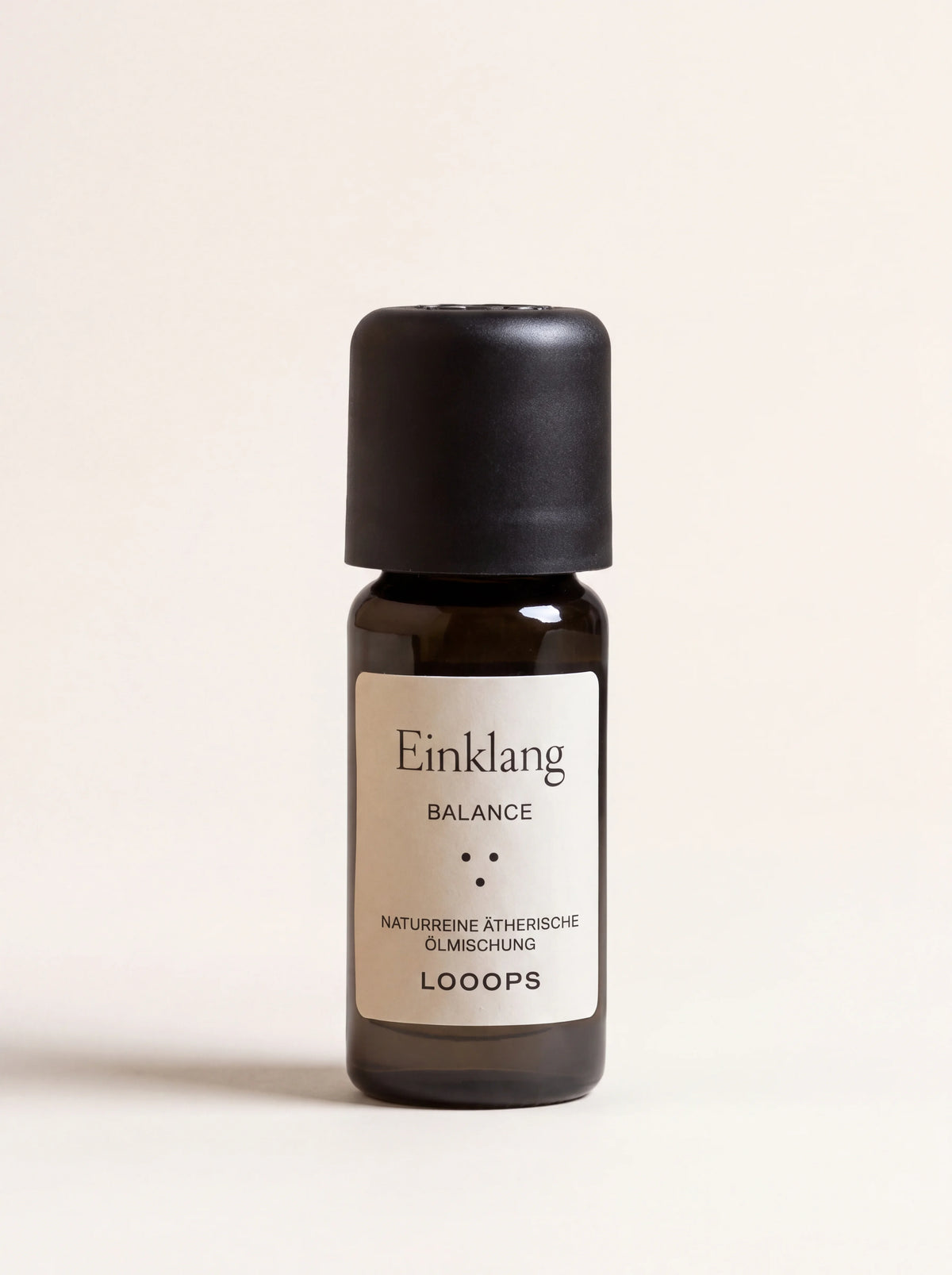 Essential oil blend in an amber glass bottle with a black cap and cream label reading Einklang Balance