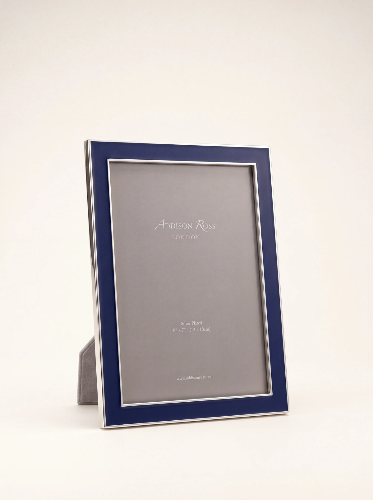 Silver-plated photo frame with navy blue enamel border and grey velvet easel back in portrait orientation