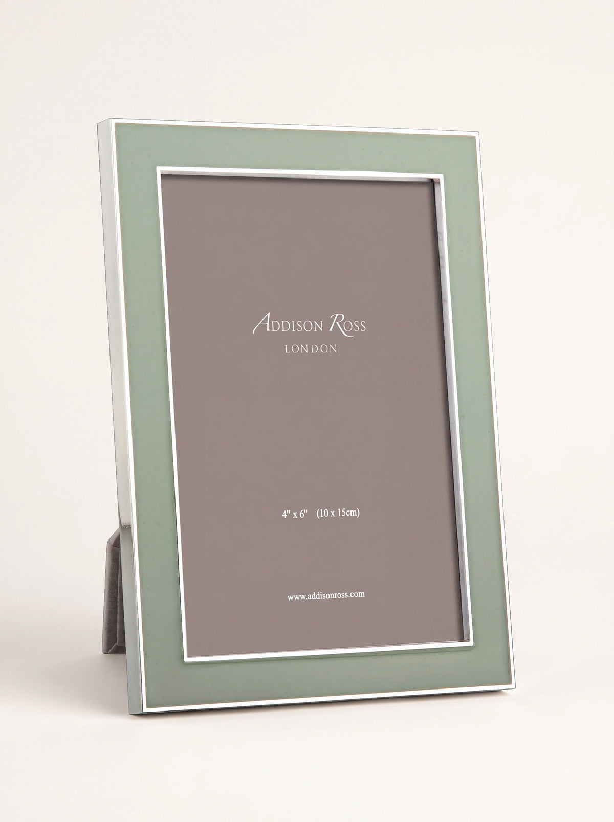 Silver-plated photo frame with a pale sage green enamel border, standing in portrait orientation