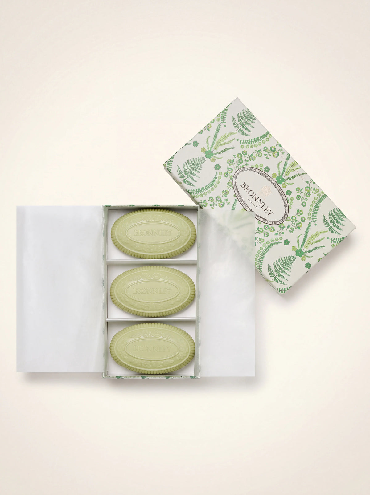 Three light green oval soaps in an open presentation box with fern-patterned lid reading BRONNLEY ENGLAND