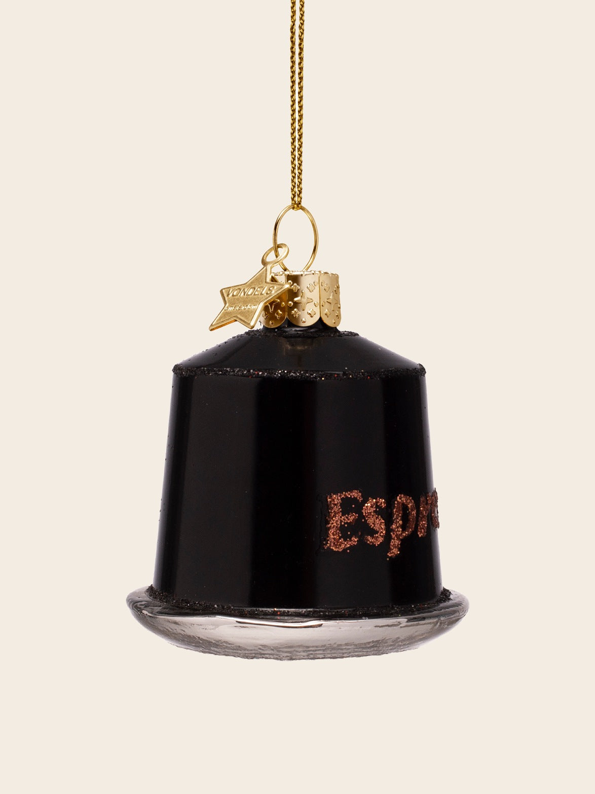 Angled view of the espresso capsule ornament showing the curved glossy black body and glitter detailing