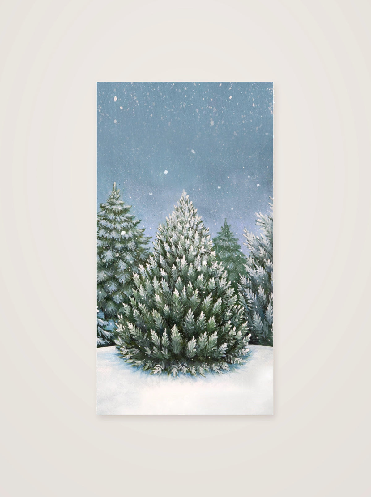 Folded paper guest napkin featuring a snow-dusted pine tree surrounded by winter woodland