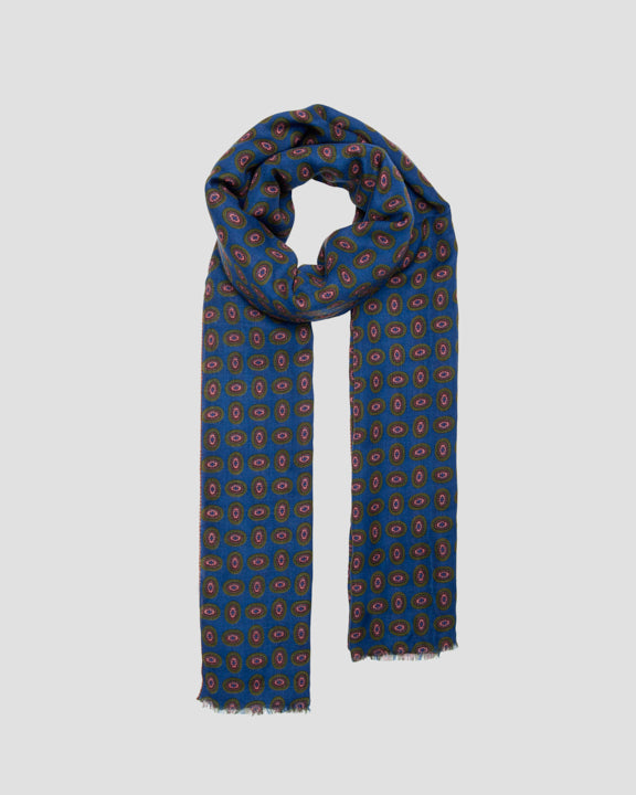 Blue wool scarf tied in a loose loop, showing its full drape and short fringed ends