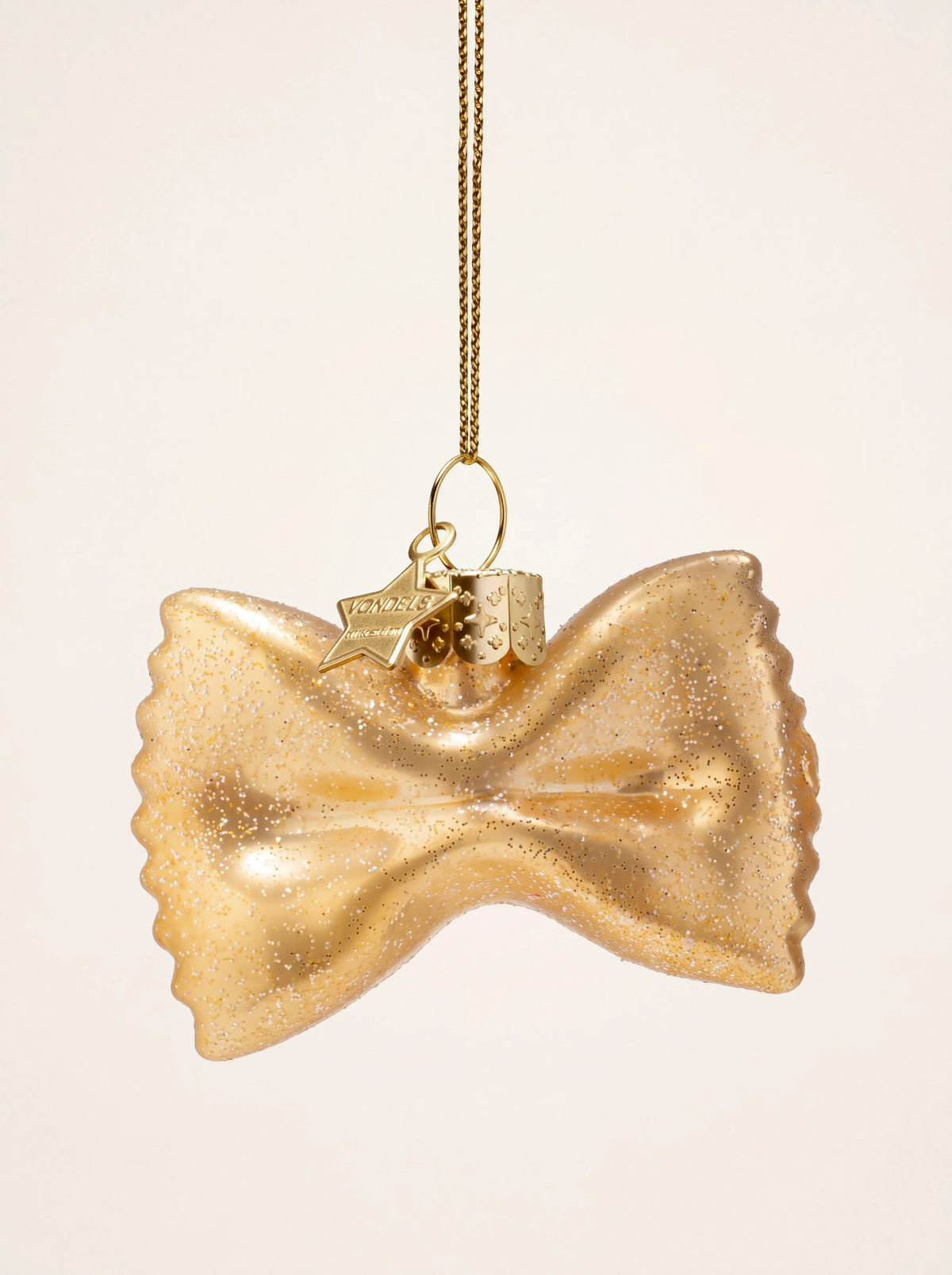 Golden glass farfalle pasta Christmas ornament with crimped edges, glitter finish, and hanging cord