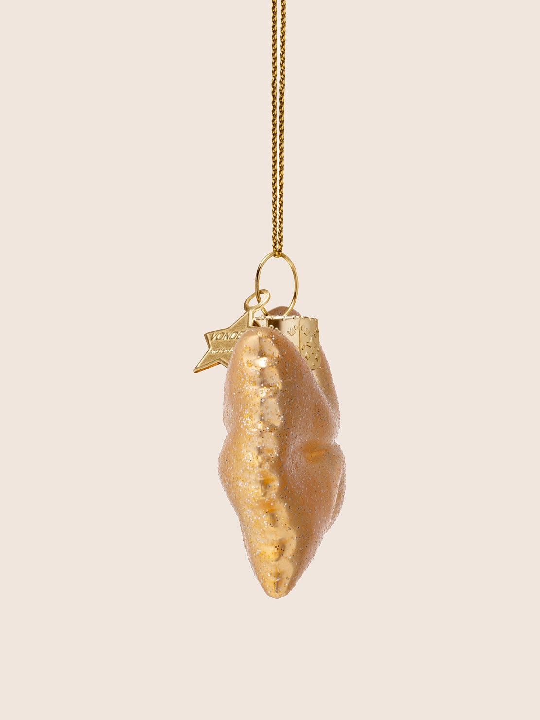 Side view of the glass farfalle ornament showing the thickness and crimped edge profile