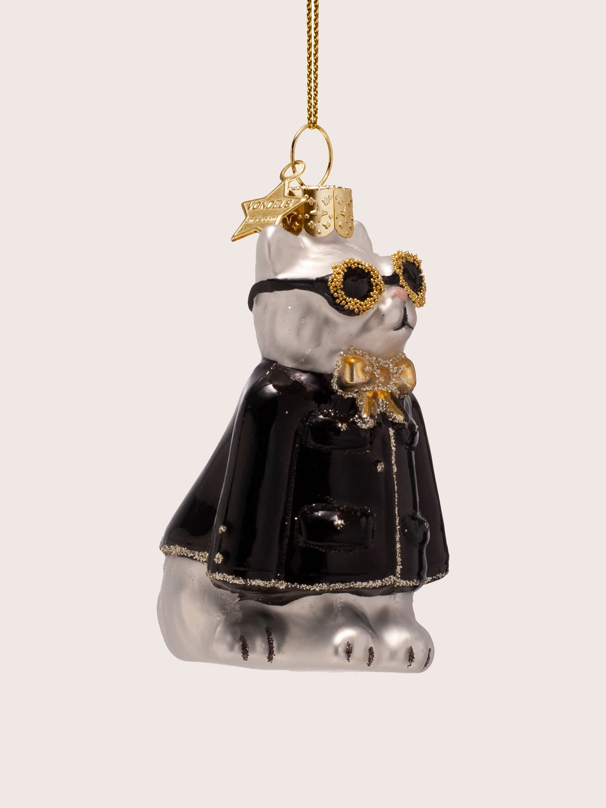 Three-quarter view of the cat ornament showing its seated pose and pocket details on the black jacket