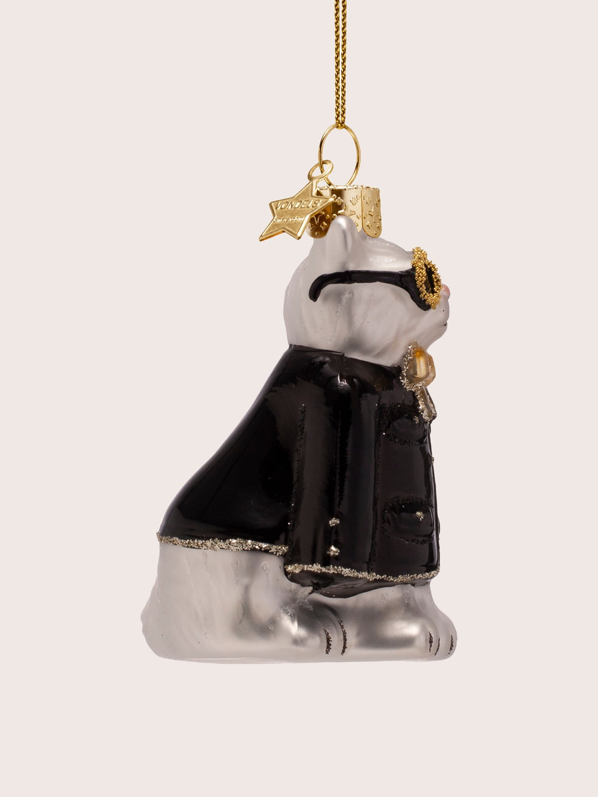 Side profile of the glass cat ornament showing the straight seated back and coat sleeve