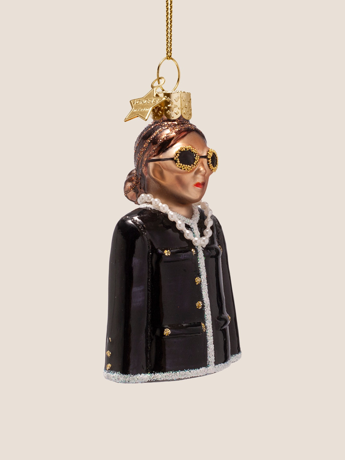 Glass woman ornament at a three-quarter angle, showing the sculpted face and jacket buttons