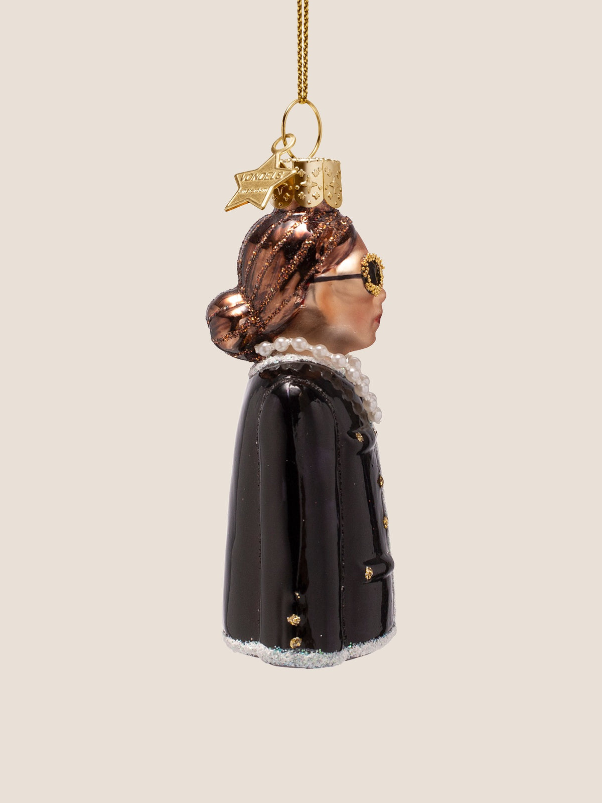 Side profile of the glass woman ornament showing the low hair bun with glitter accents