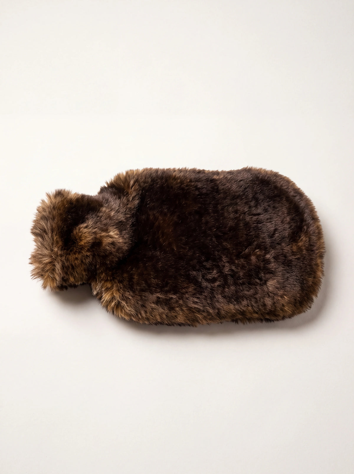 Hot water bottle with a high-pile fox-brown faux-fur cover