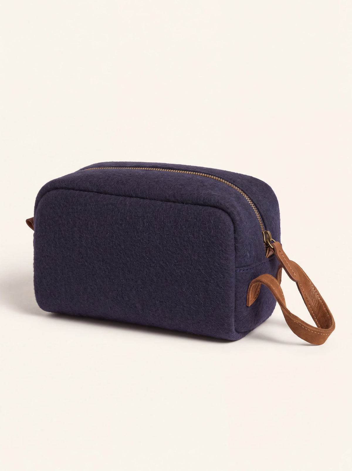 Dark blue wool felt beauty case with top zip closure and brown suede side handle