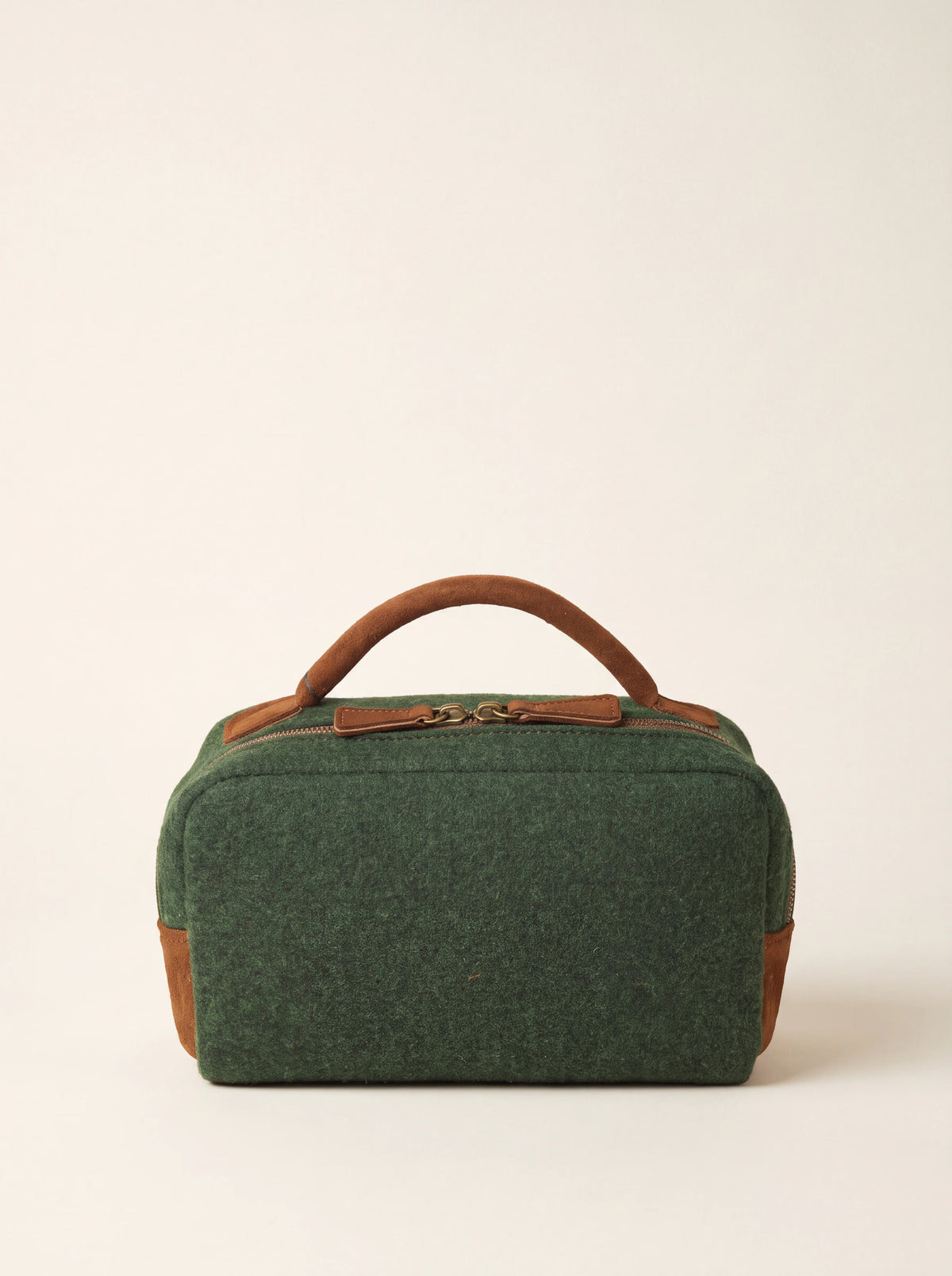Green wool felt toiletry bag with a brown suede top handle and zip closure