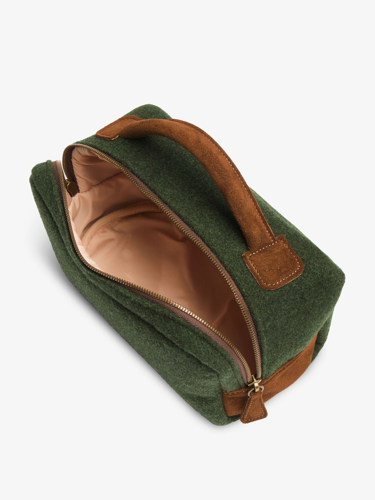 Unzipped toiletry bag seen from above, showing the light peach fabric lining