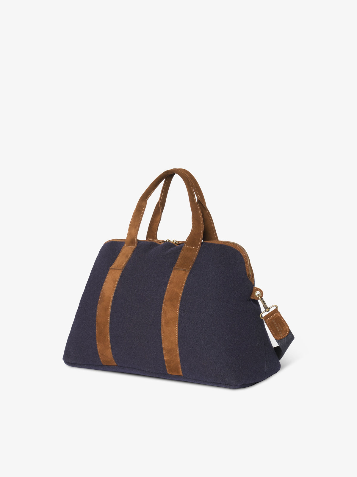 Blue felt travel bag seen from an angle, showing its structured base and brass strap clip