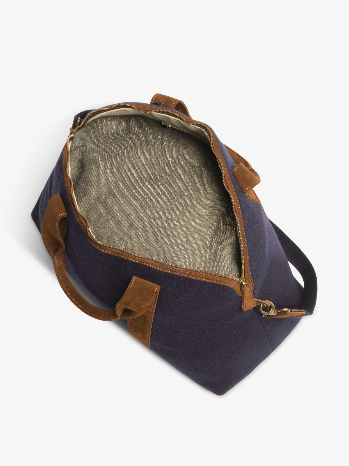 Unzipped travel bag viewed from above, showing the roomy woven fabric interior lining