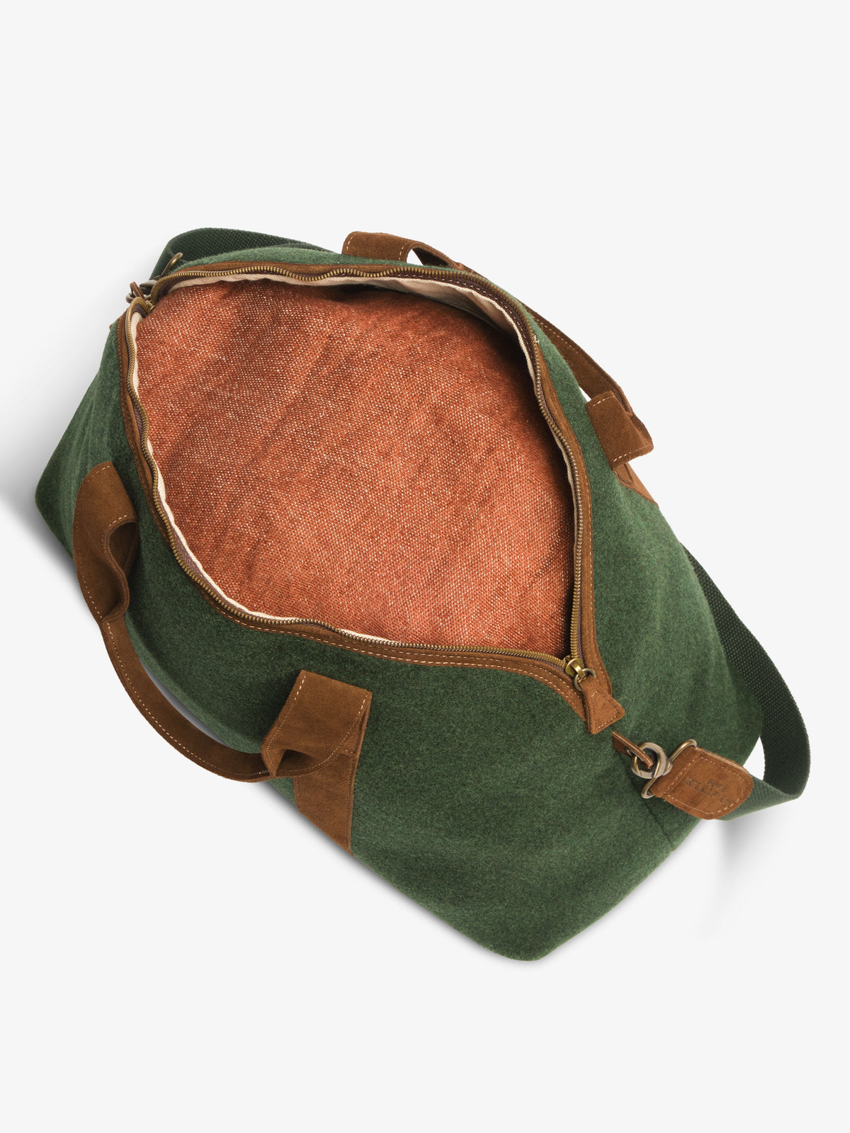 Top-down view into the unzipped green felt travel bag showing the woven terracotta lining