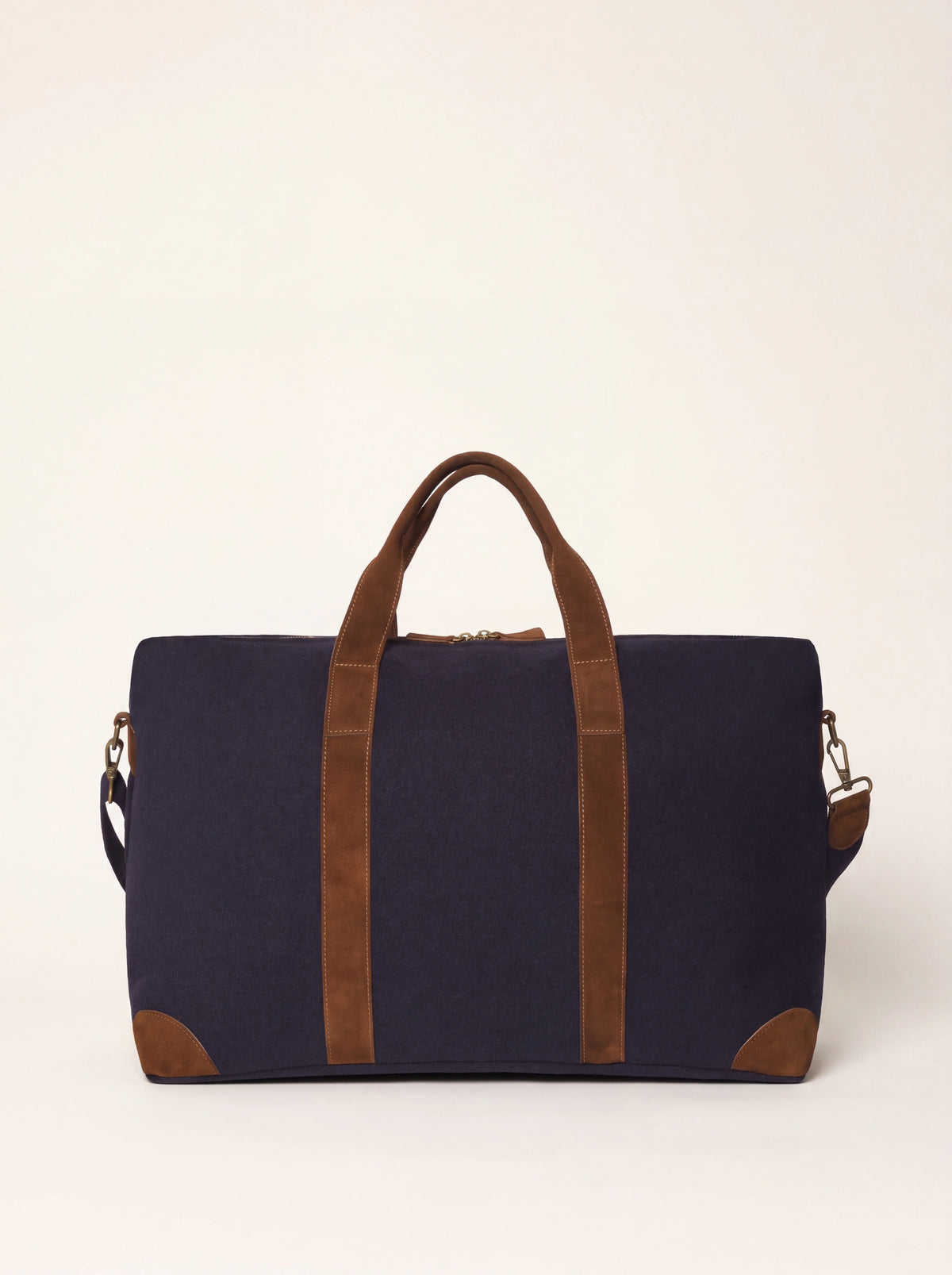 Dark blue wool felt weekender bag with brown suede handles and reinforced corners
