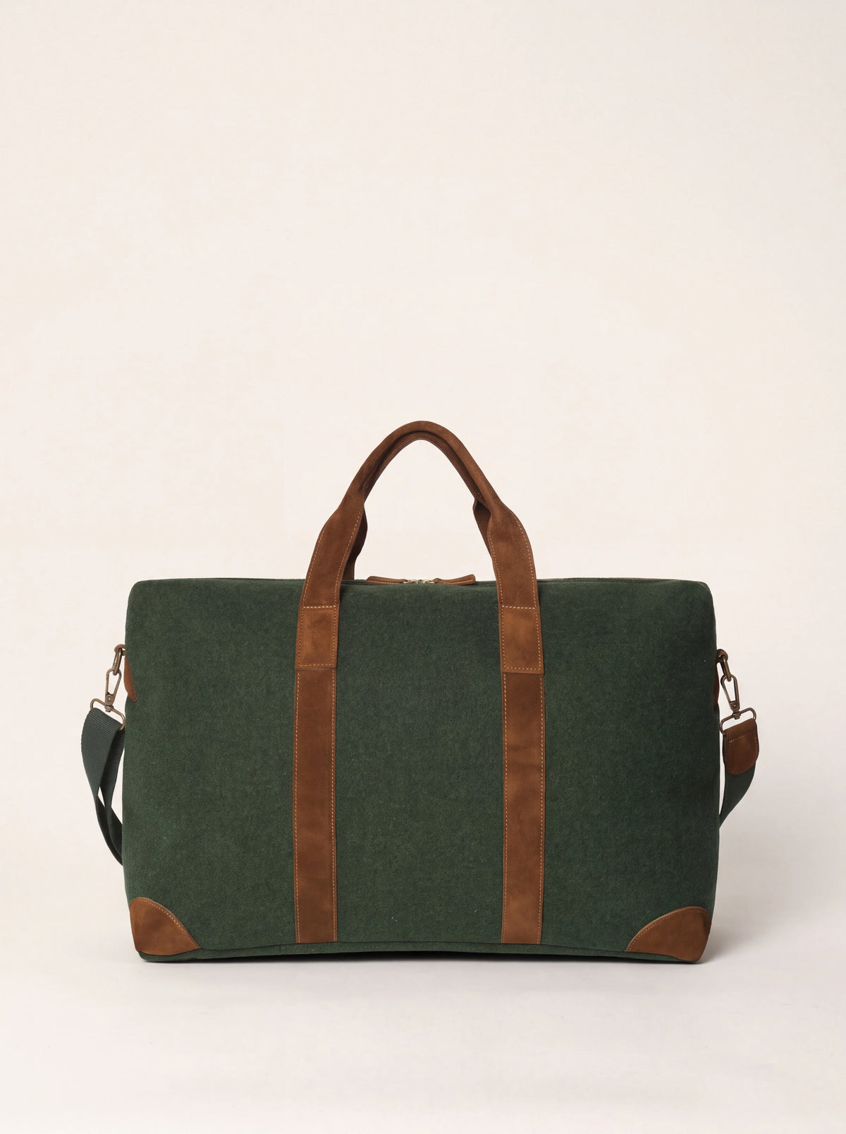 Green wool felt weekender bag with brown suede handles, corner patches and a shoulder strap