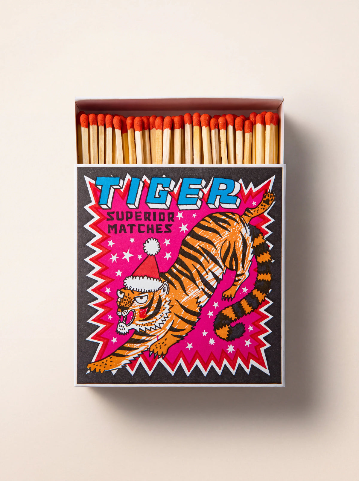 Open matchbox showing red-tipped matches, with a festive tiger illustration and text 'TIGER SUPERIOR MATCHES