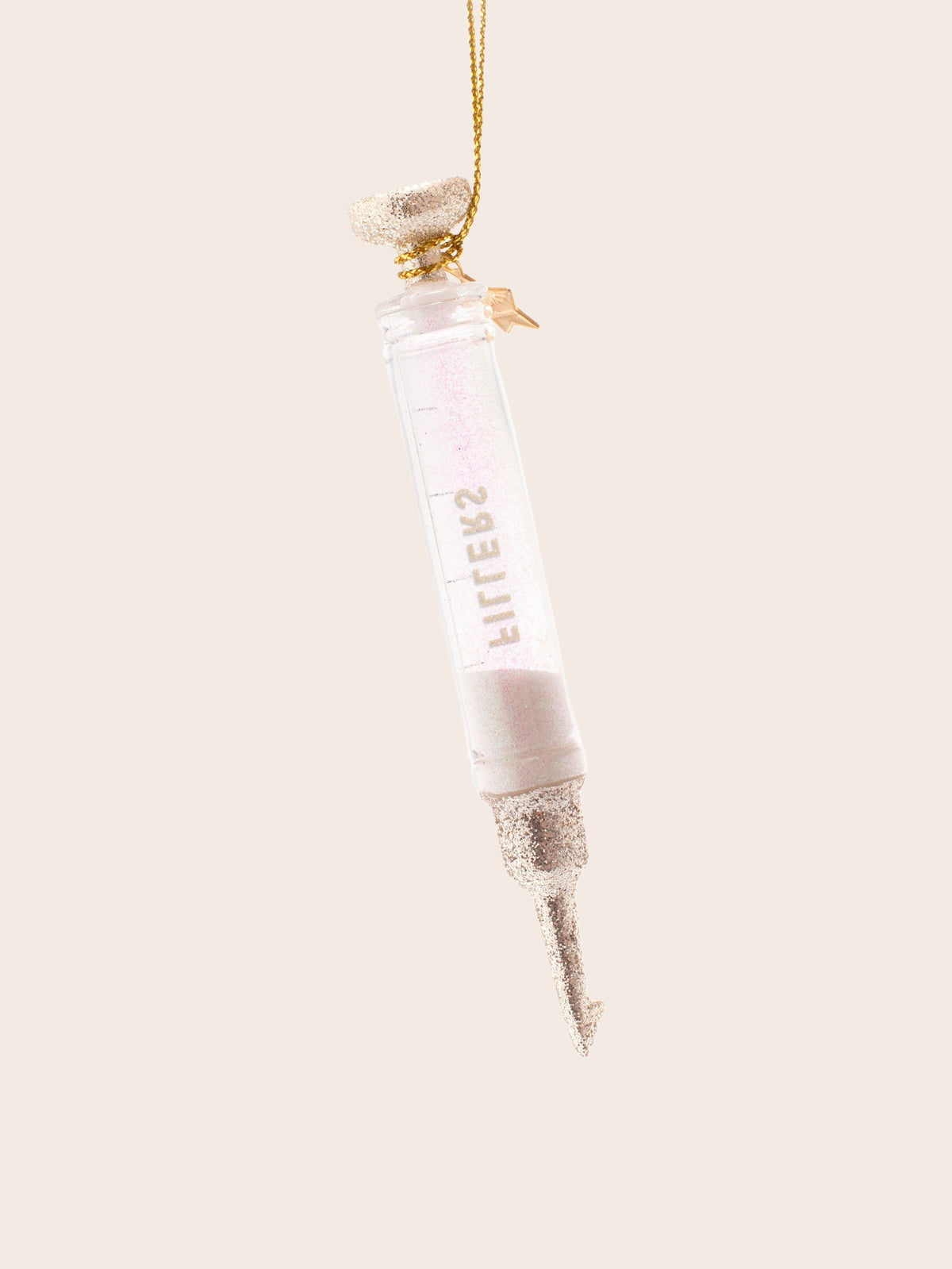 Reverse side of the glass syringe ornament showing the mirrored lettering and glitter details
