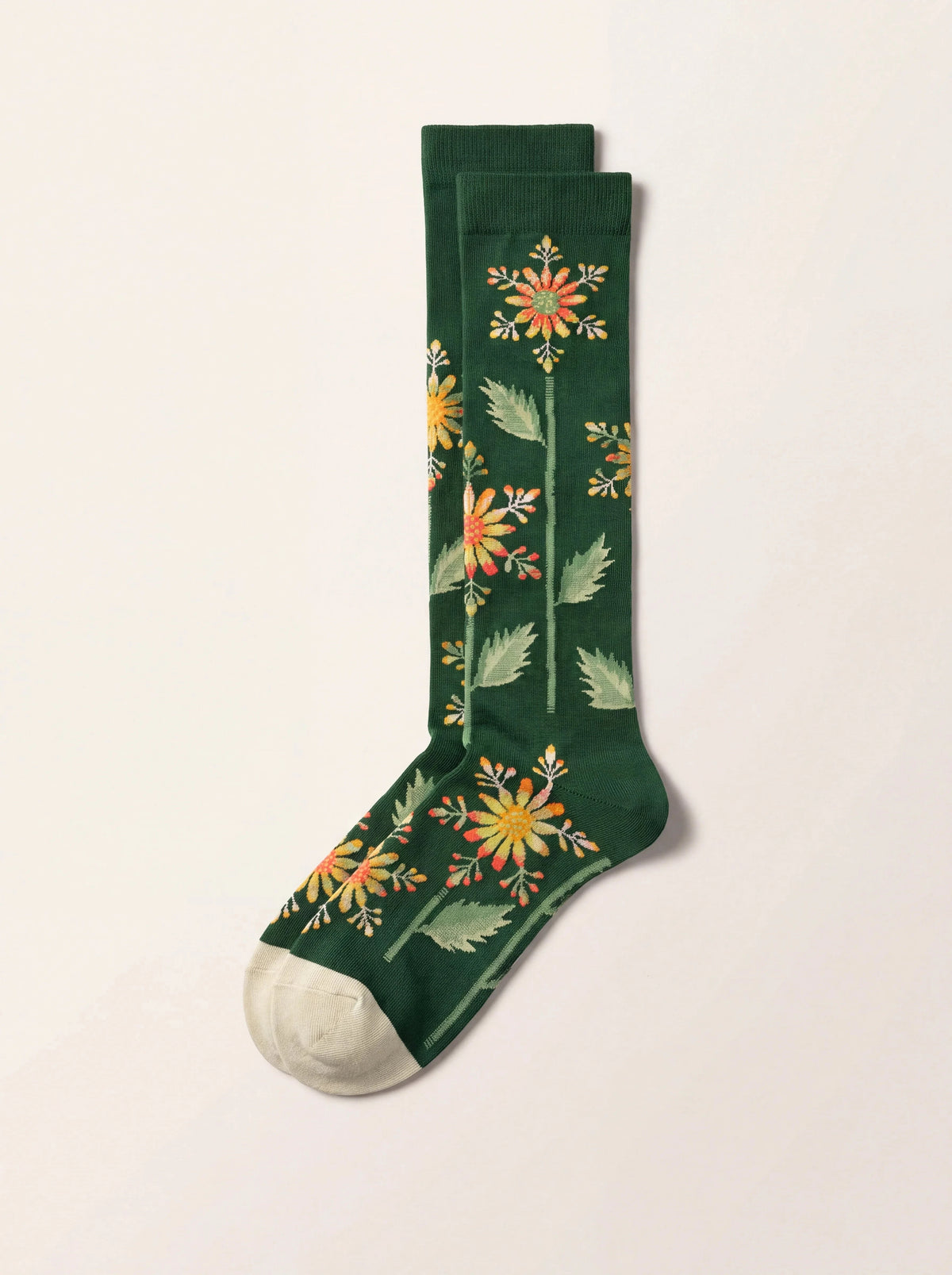 Dark green cotton knee-high socks with an orange floral stem pattern and cream toes