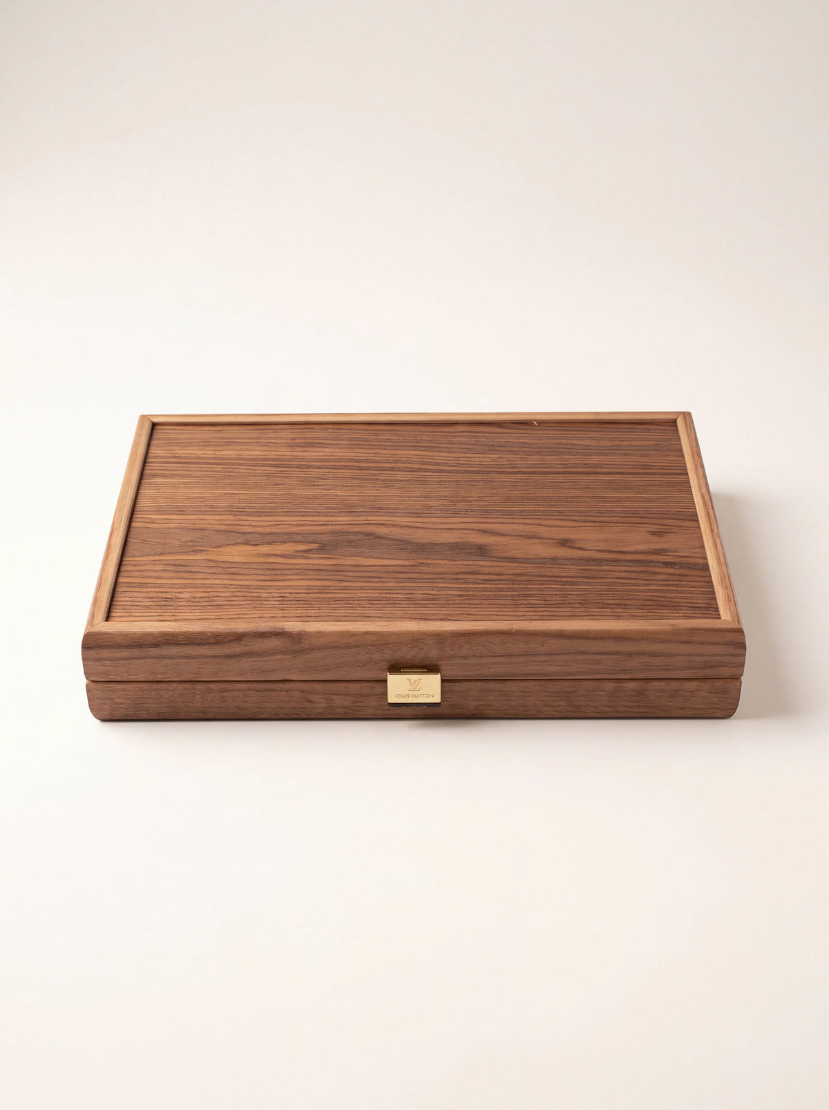 Closed wooden backgammon case showing the natural wood grain and metal clasp