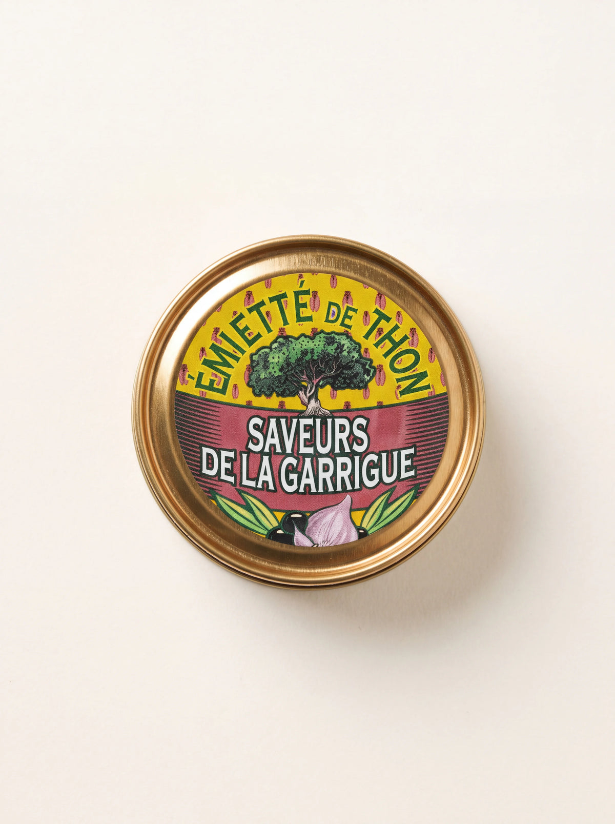 Round tin of flaked tuna with a lid label reading Émietté de Thon Saveurs de la Garrigue