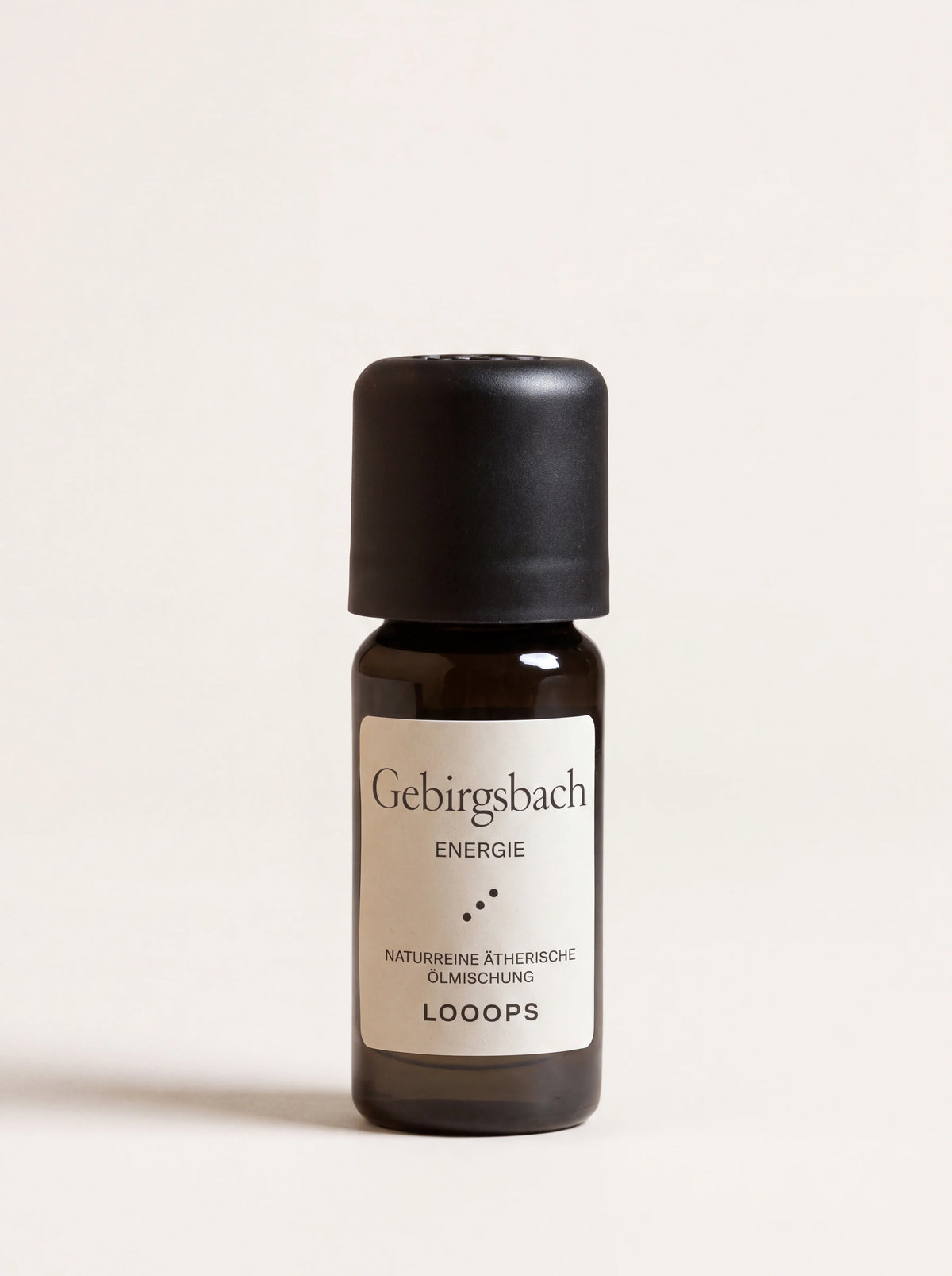 Gebirgsbach essential oil in an amber glass dropper bottle with a black cap and cream label