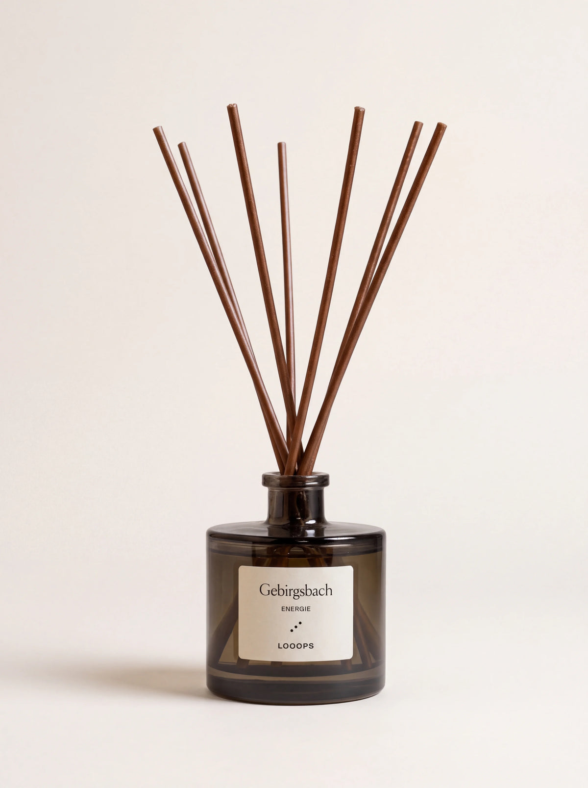 Reed diffuser in a cylindrical tinted glass bottle with brown paper reeds and Gebirgsbach label