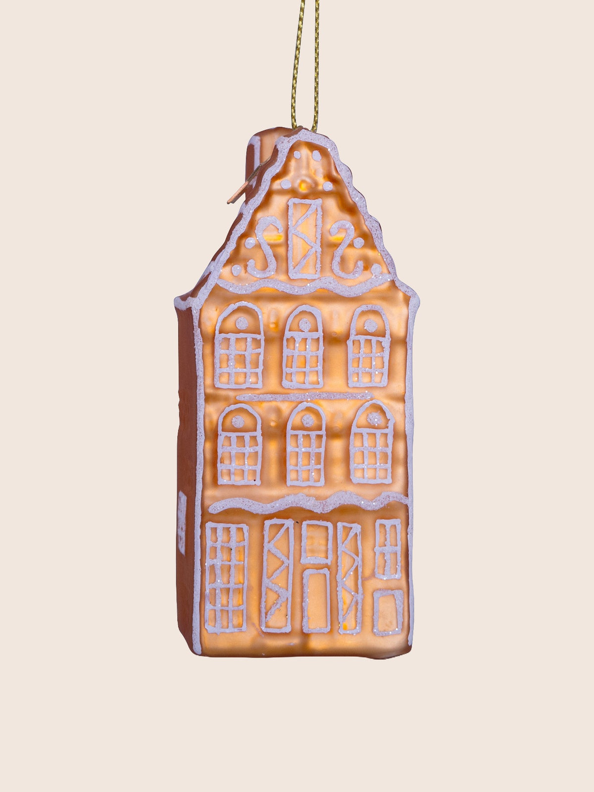 Front view showing the decorative gable and three storeys of windows and doors outlined in white