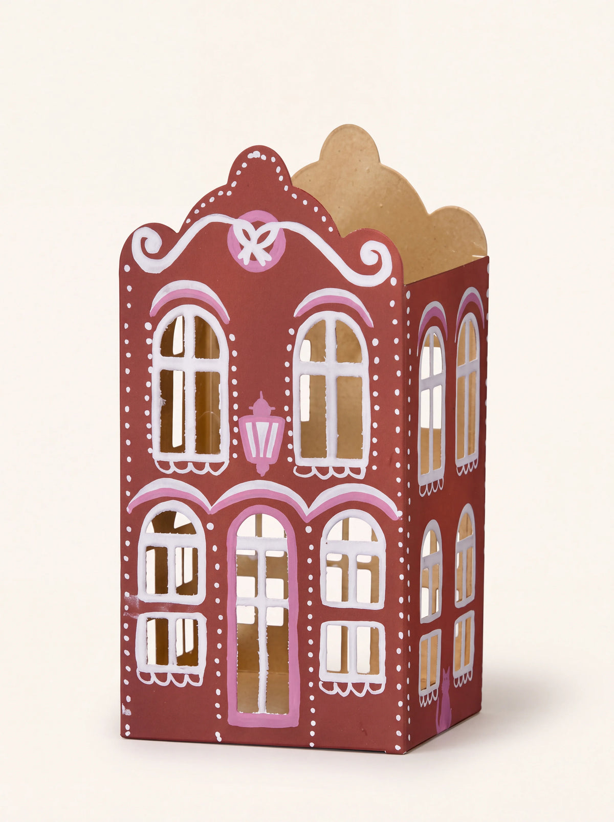 Scarlet iron gingerbread house candle holder with cut-out windows, painted icing details and open top