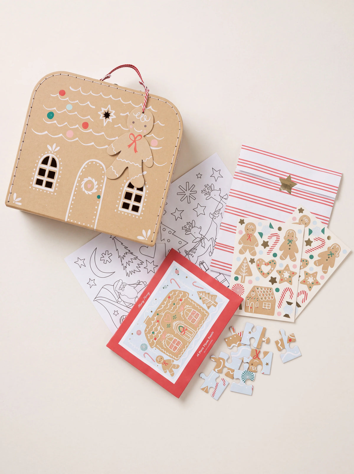 Gingerbread house cardboard suitcase shown with puzzle, colouring poster and two sticker sheets