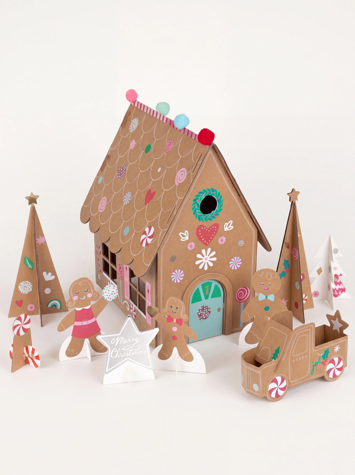 Gingerbread paper advent calendar assembled with a slot-together house, figures, trees and a truck