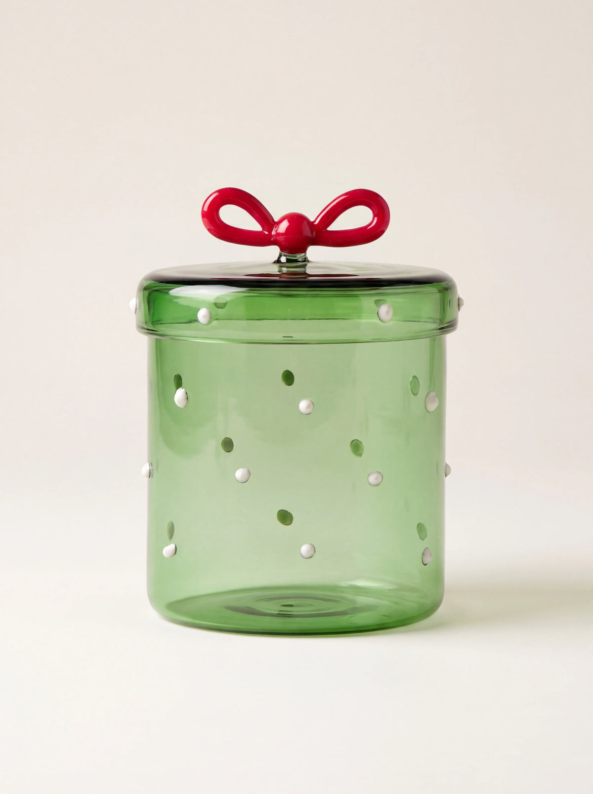 Green borosilicate glass box with raised white and green dots and a red glass bow on the lid
