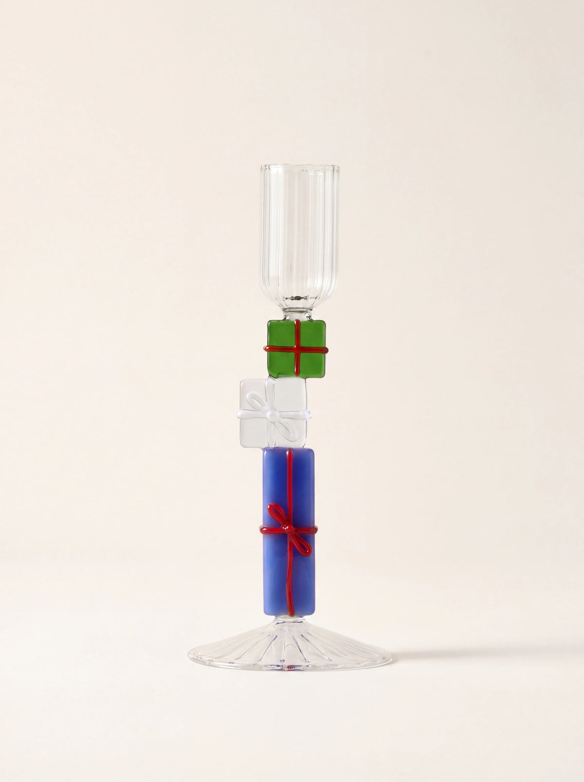 Glass candle holder with ribbed top, stacked green, white and blue gift-box stem and fluted clear base