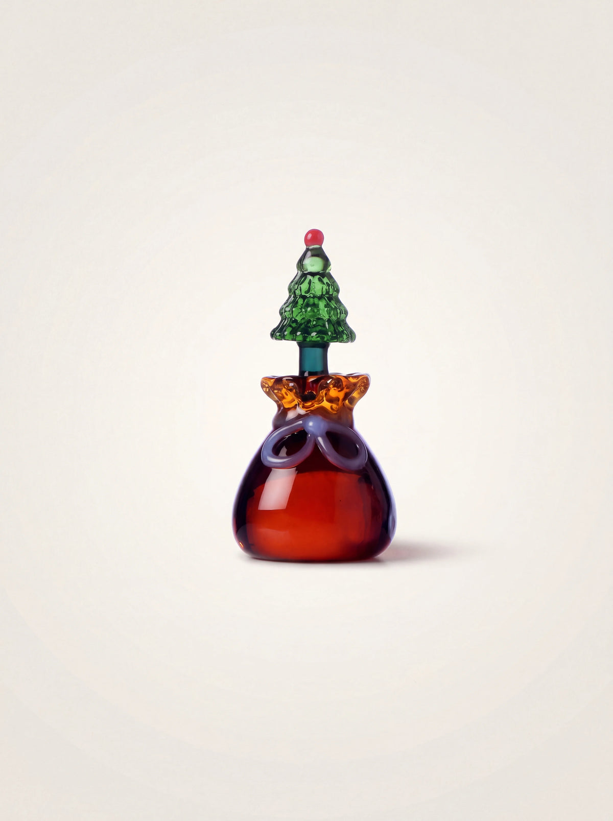 Borosilicate glass place marker shaped as an amber sack with a bow, topped with a miniature green tree