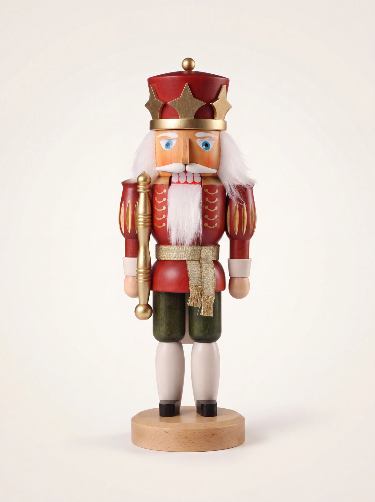 King wooden nutcracker with a crown and sceptre, wearing a red jacket with gold trim and green trousers