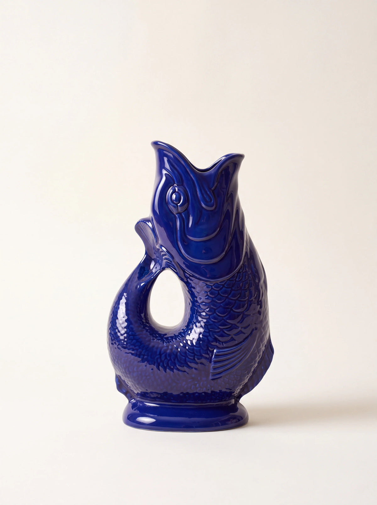 Cobalt blue glazed porcelain Gluggle jug shaped like an upright fish with an open-mouth spout