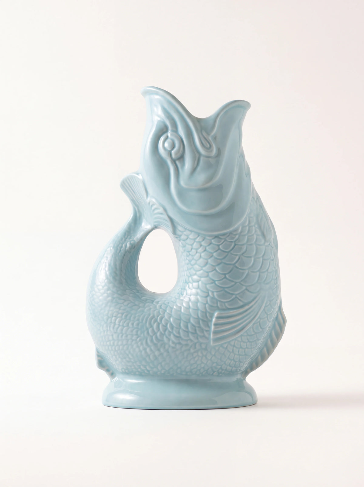Glazed porcelain fish jug in eau de nil with open mouth spout, curved tail handle and scale relief