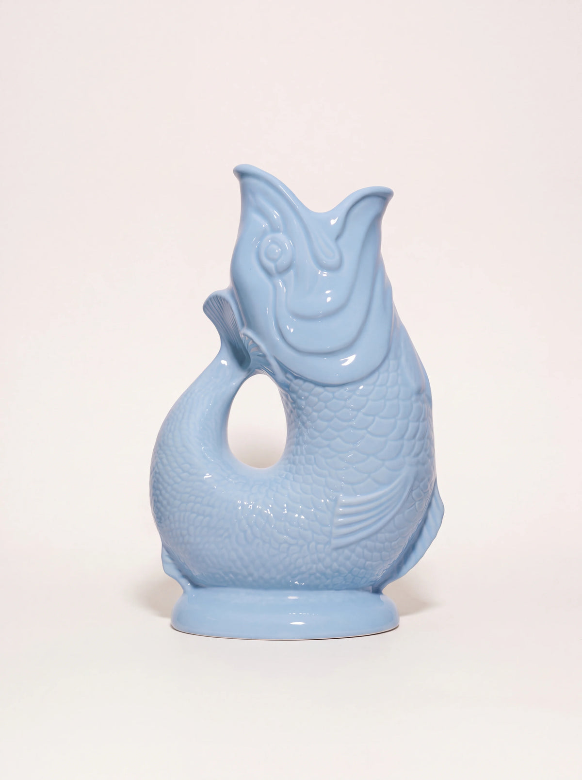 Pale blue glazed porcelain Gluggle jug shaped like a fish with an open-mouth spout and curved tail handle