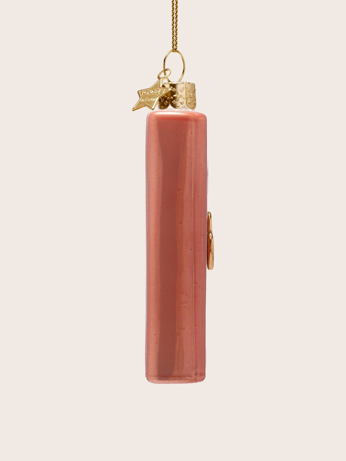 Side profile of the pink glass diary ornament showing the smooth rounded spine