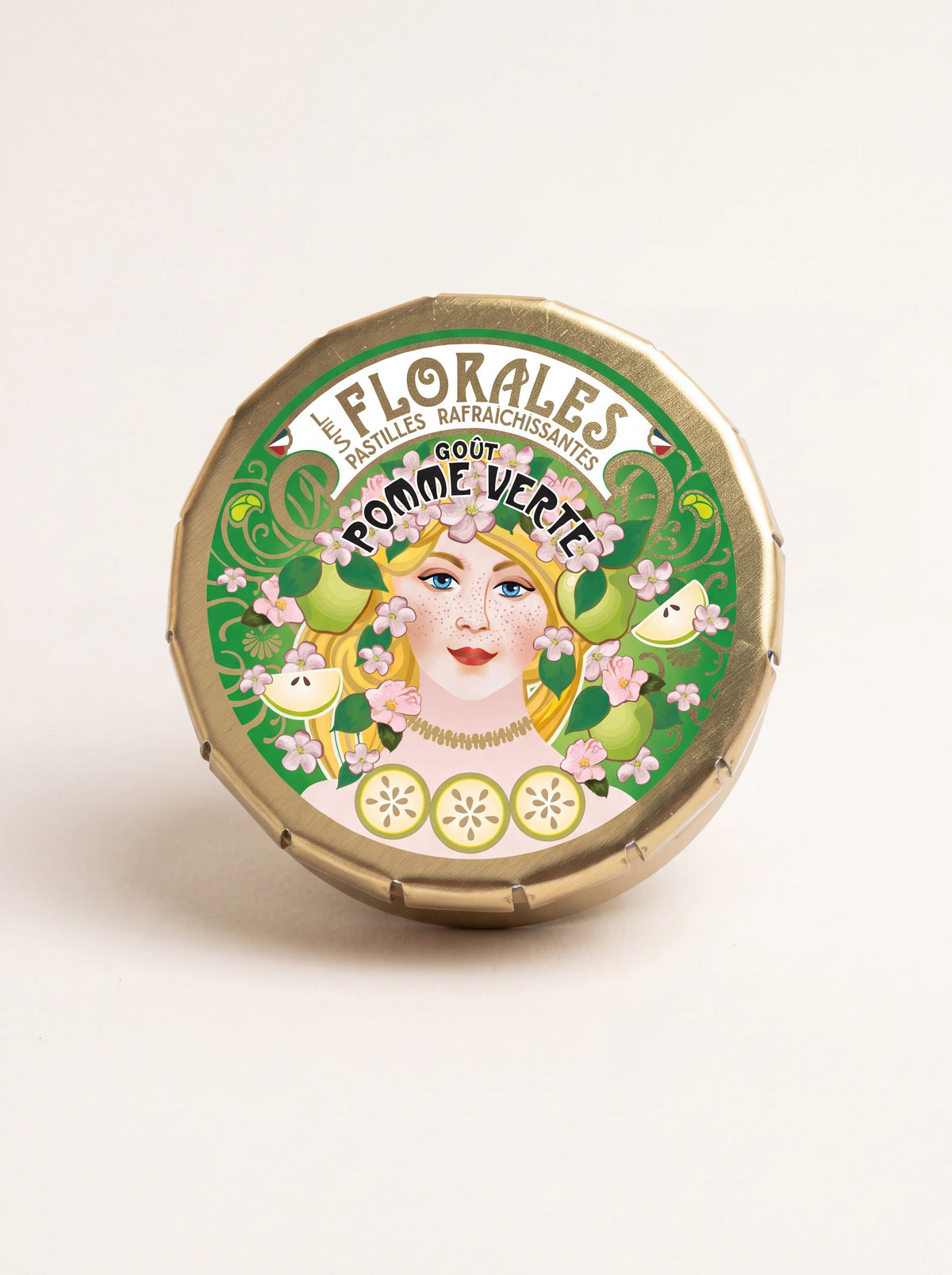 Round gold-tone tin with an illustrated lid reading Les Florales Pastilles Rafraîchissantes Goût Pomme Verte