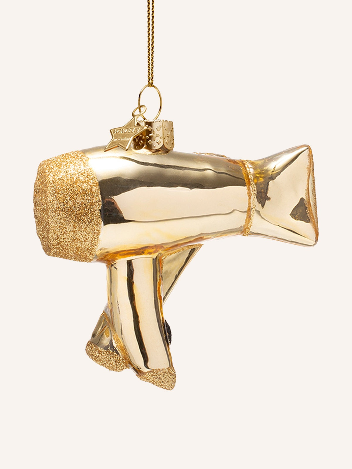 Opposite side profile of the gold hair dryer ornament showing the full barrel and nozzle