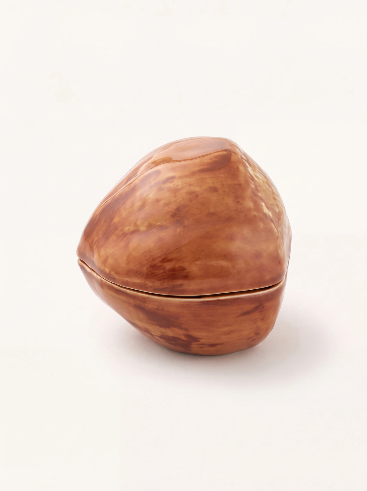 Hazelnut-shaped glazed earthenware box with a fitted lid in glossy mottled brown