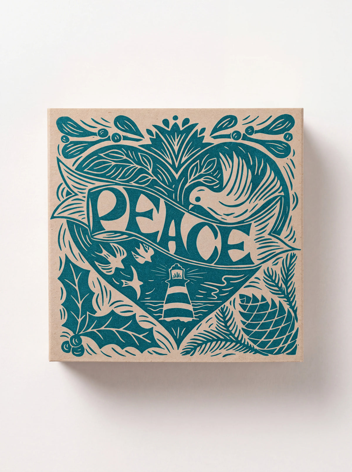 Closed square matchbox featuring a teal linocut heart design with a dove, lighthouse and the word PEACE