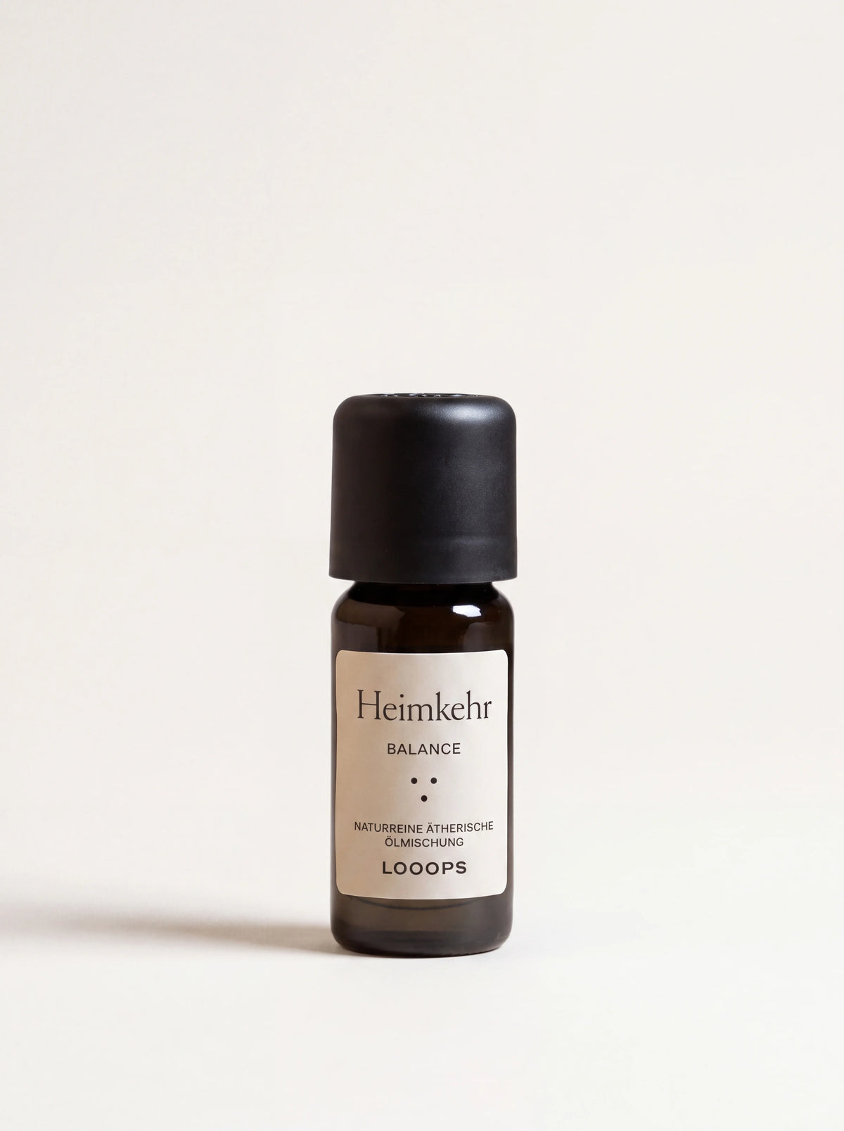 Heimkehr Balance essential oil in an amber glass bottle with a matte black cap