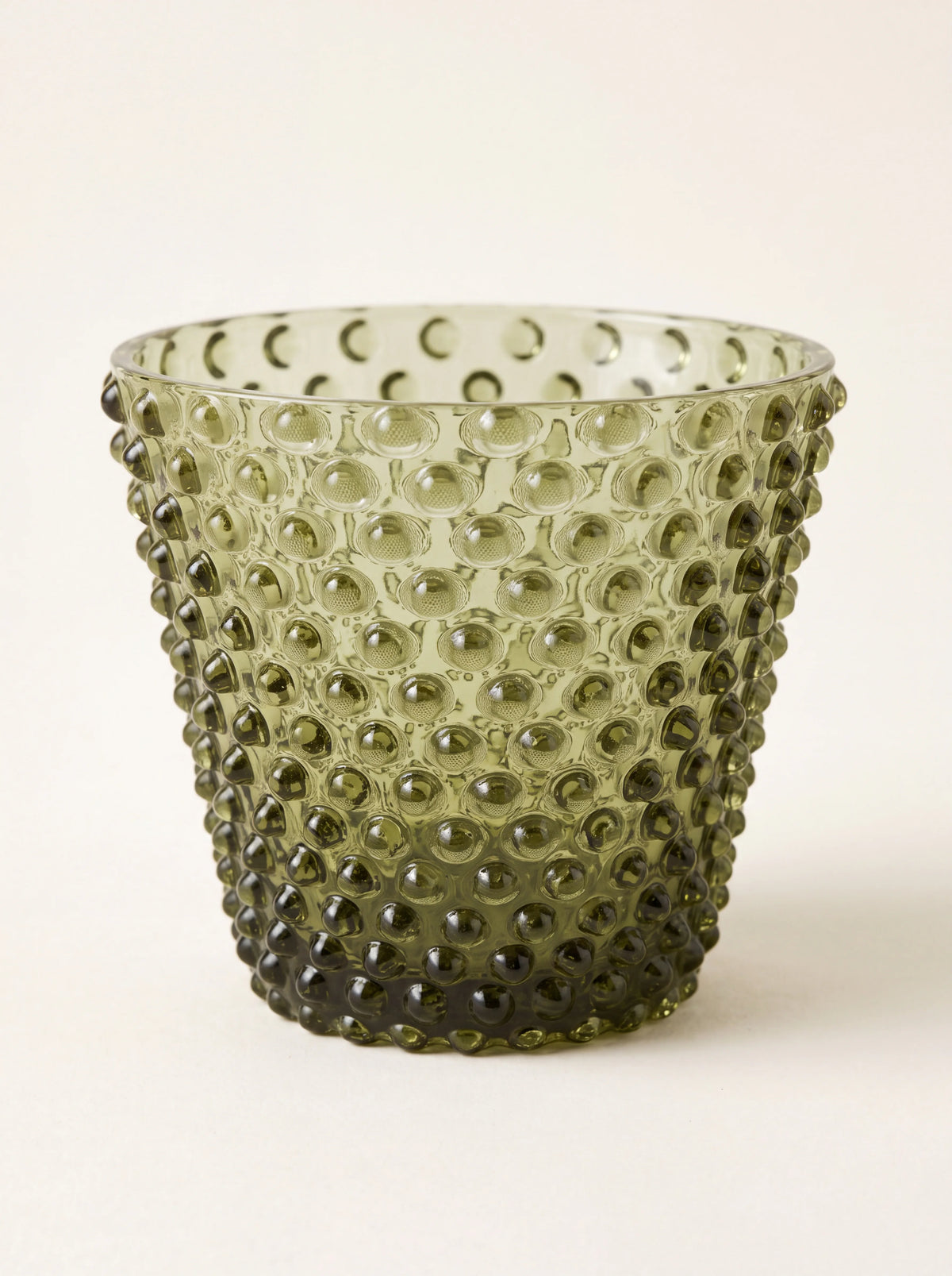 Forest green glass tealight holder with an all-over raised hobnail pattern and smooth rim