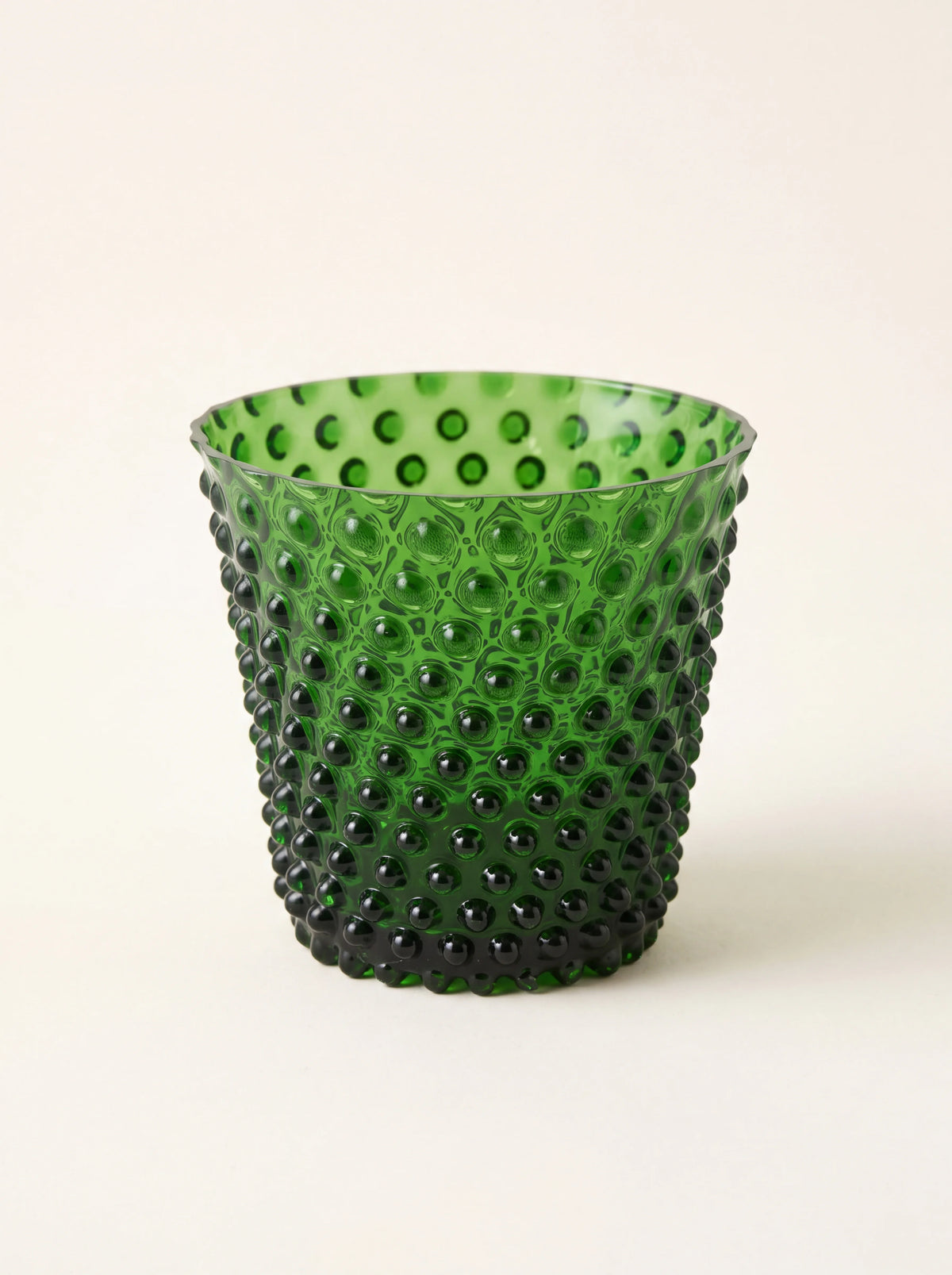 Green hobnail glass tealight holder with an all-over raised texture and smooth rim
