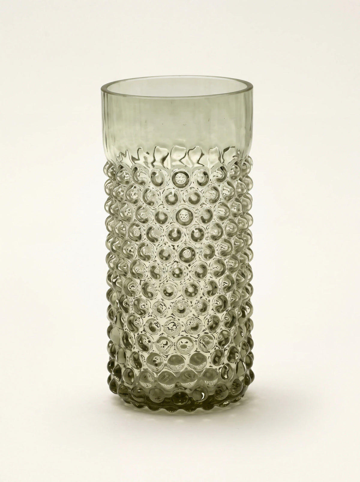 Forest green glass tumbler with a raised hobnail texture and a smooth upper rim